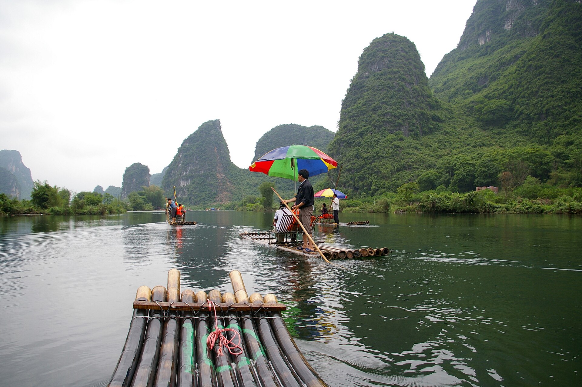 Bamboo rafting on the Yulong River among the karst peaks of Yangshuo